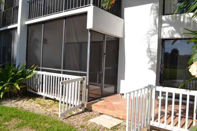 view of side of property with a sunroom