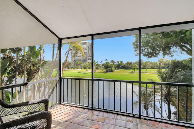 unfurnished sunroom featuring a water view