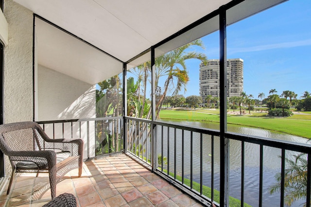 unfurnished sunroom with a water view