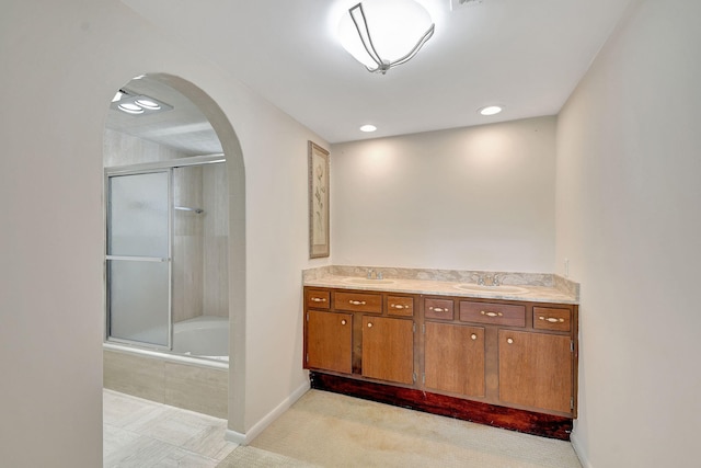 bathroom featuring tile patterned floors, vanity, and combined bath / shower with glass door