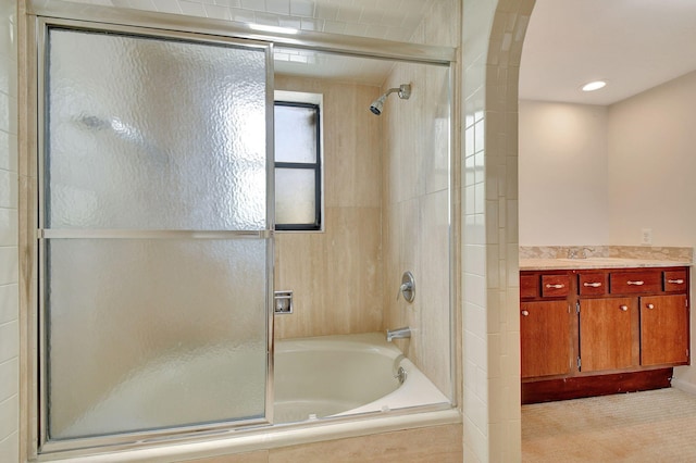 bathroom with vanity and enclosed tub / shower combo