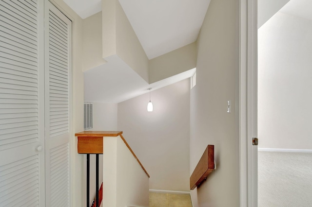 stairway with carpet flooring and lofted ceiling