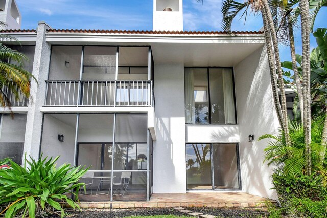 back of property with a balcony