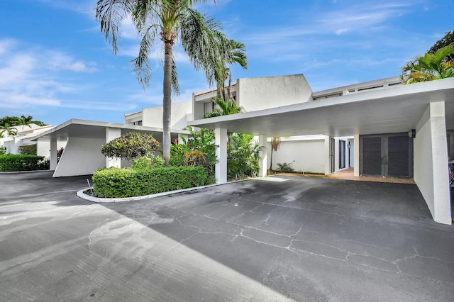 contemporary house featuring a carport