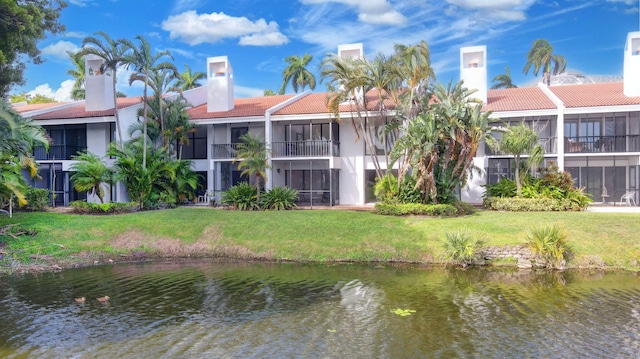 exterior space with a water view and a yard