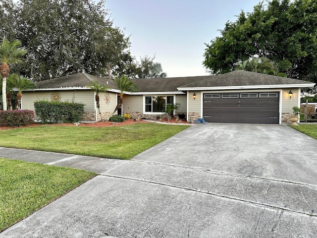 ranch-style home with a front lawn and a garage