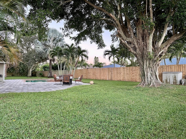 view of yard with a patio area and a fenced in pool