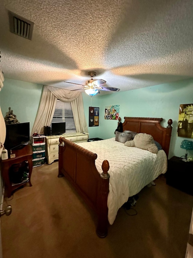 carpeted bedroom with a textured ceiling and ceiling fan