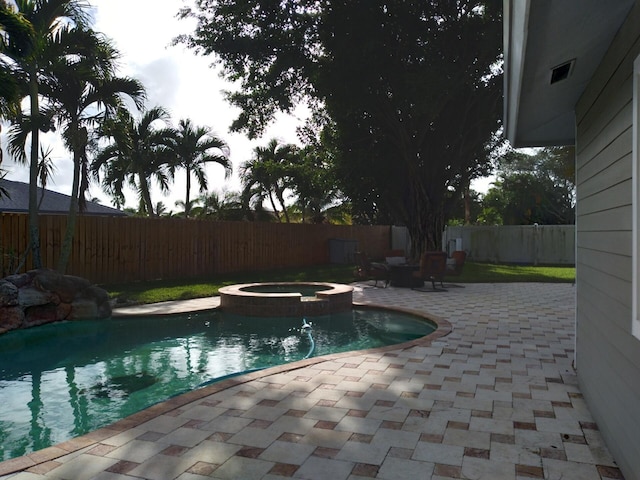 view of pool featuring an in ground hot tub and a patio