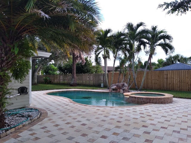 view of pool featuring an in ground hot tub and a patio