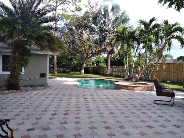 view of swimming pool with an in ground hot tub and a patio