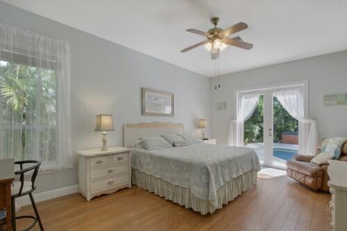 bedroom featuring french doors, ceiling fan, access to outside, and light wood-type flooring