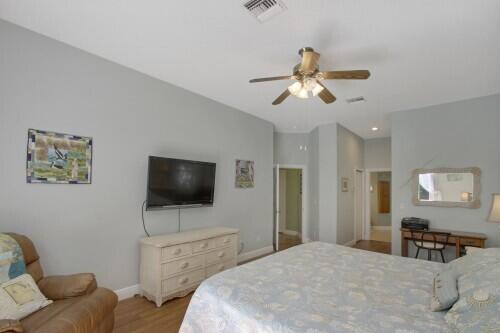 bedroom with ceiling fan and light wood-type flooring