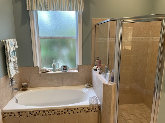 bathroom featuring shower with separate bathtub and a healthy amount of sunlight