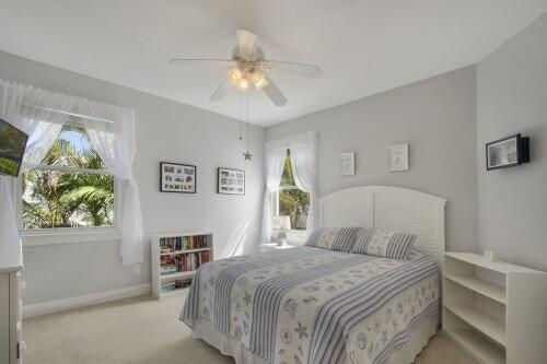 bedroom featuring ceiling fan and light carpet