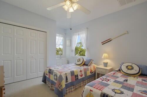 carpeted bedroom featuring a closet and ceiling fan