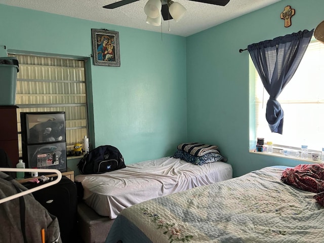 bedroom featuring a textured ceiling and ceiling fan