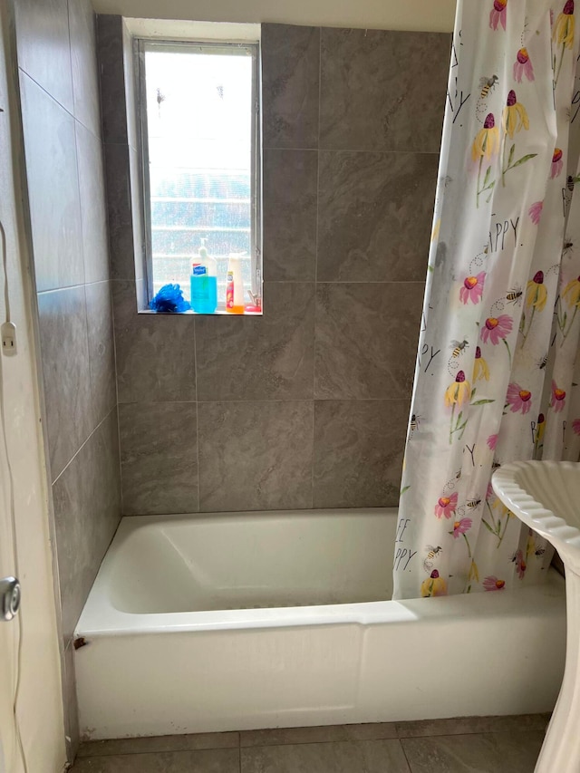 bathroom featuring shower / bath combo, a healthy amount of sunlight, and tile flooring