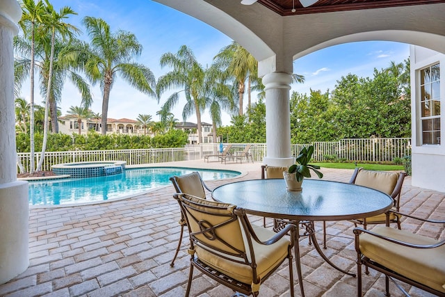 view of swimming pool featuring a patio and an in ground hot tub