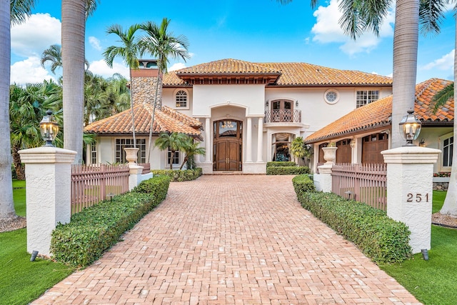 mediterranean / spanish home with a garage