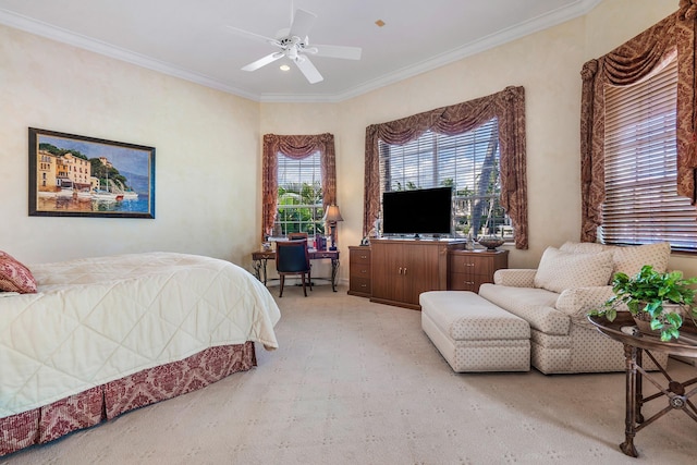 carpeted bedroom with ornamental molding and ceiling fan