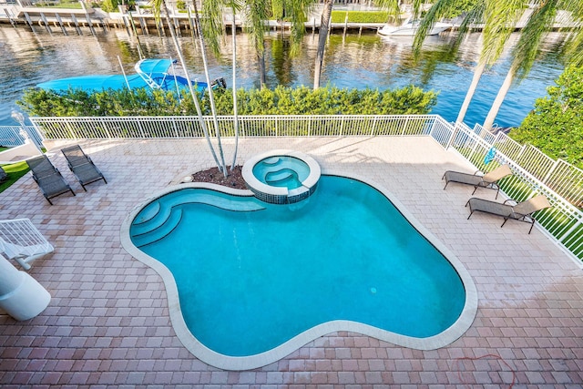 view of pool with a water view and a patio area