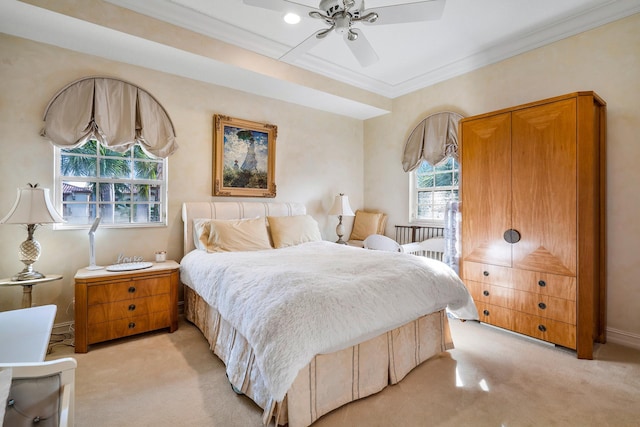 bedroom with ceiling fan, light colored carpet, and multiple windows