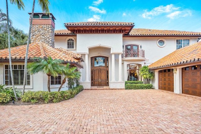 mediterranean / spanish house with a balcony and a garage