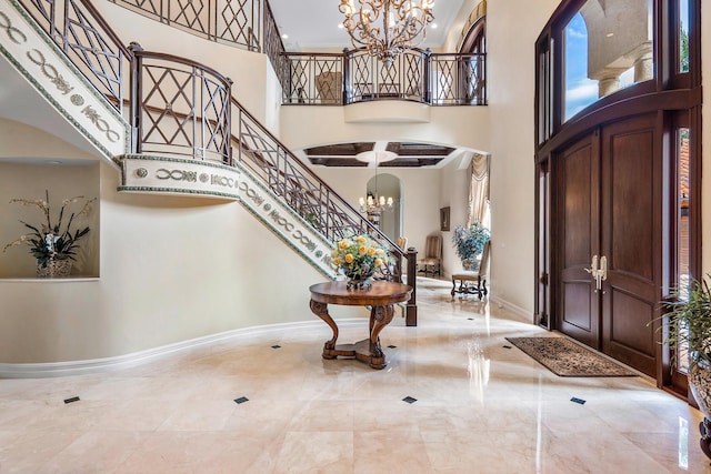 foyer with a towering ceiling and a chandelier