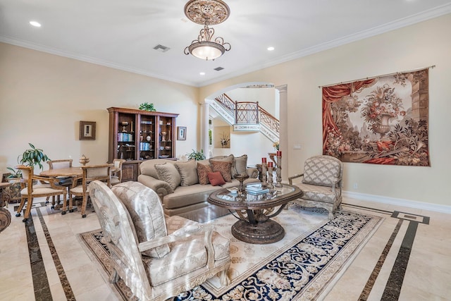 living room with ornamental molding and decorative columns