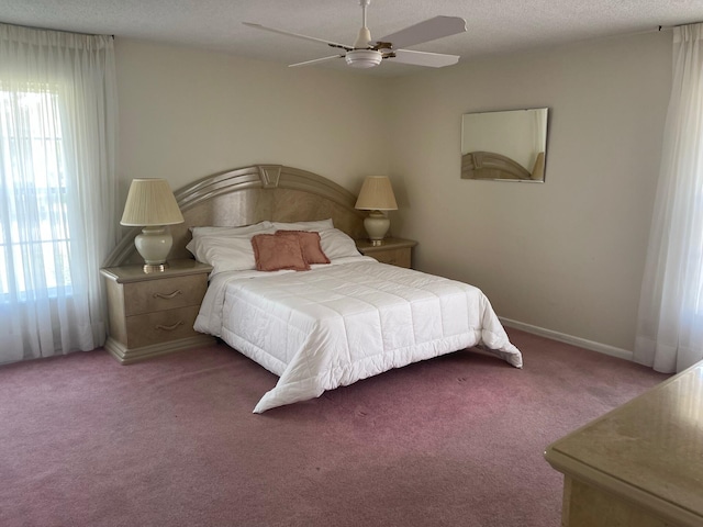 bedroom with carpet floors, a textured ceiling, and ceiling fan