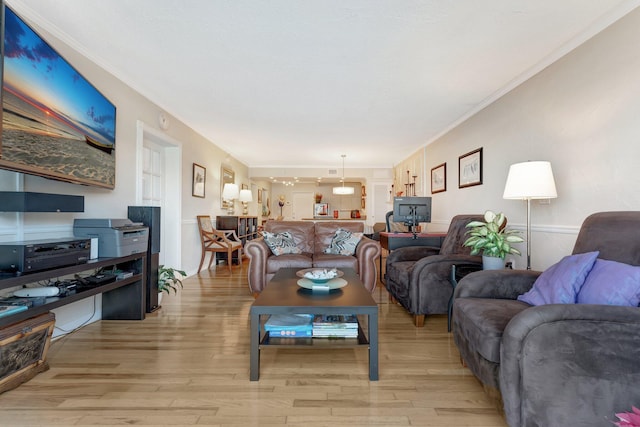 living room featuring ornamental molding and light hardwood / wood-style floors