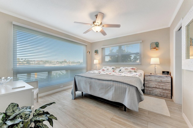 bedroom featuring ornamental molding, ceiling fan, and light wood-type flooring