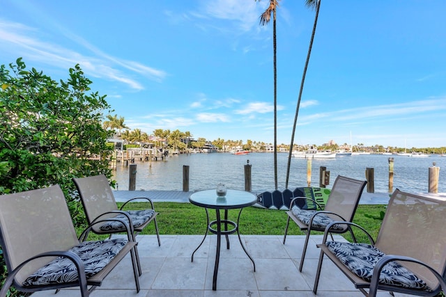 view of patio / terrace with a water view and a boat dock