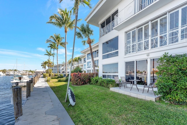 exterior space with a lawn and a water view