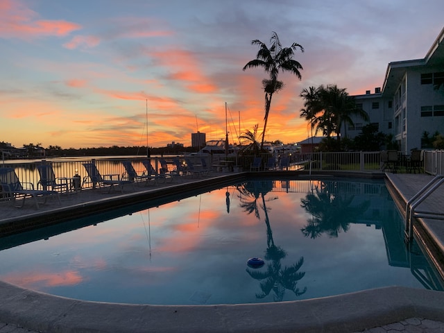 view of pool at dusk