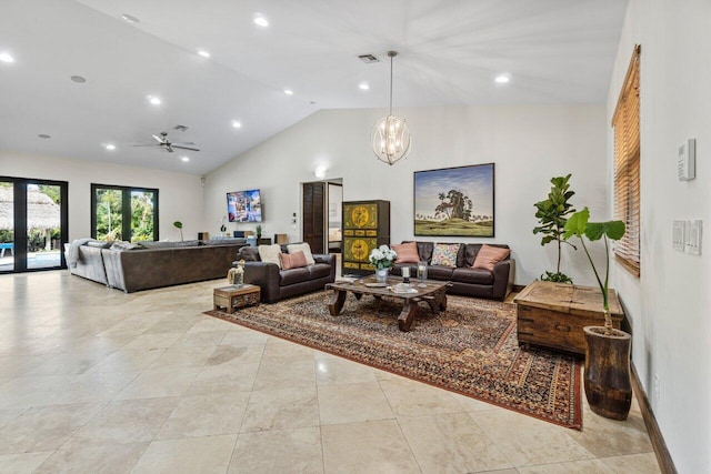 tiled living room featuring high vaulted ceiling, ceiling fan with notable chandelier, and french doors