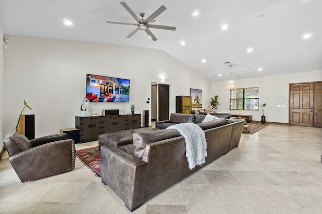 tiled living room featuring high vaulted ceiling and ceiling fan with notable chandelier