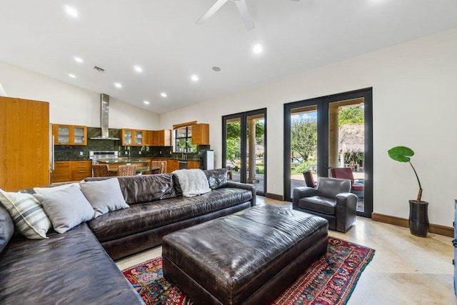 living room featuring light tile floors, high vaulted ceiling, and ceiling fan