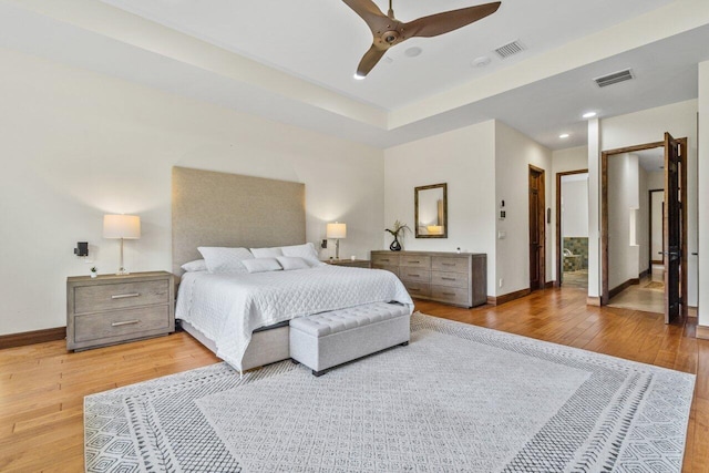 bedroom with light hardwood / wood-style floors and ceiling fan