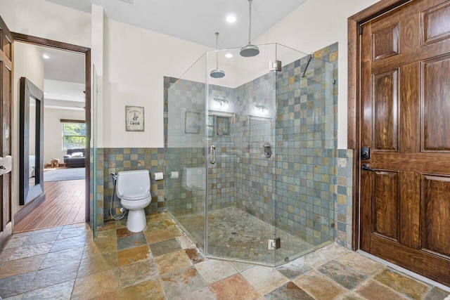 bathroom featuring an enclosed shower, toilet, and tile flooring