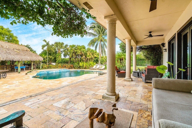 view of swimming pool with outdoor lounge area, ceiling fan, and a patio