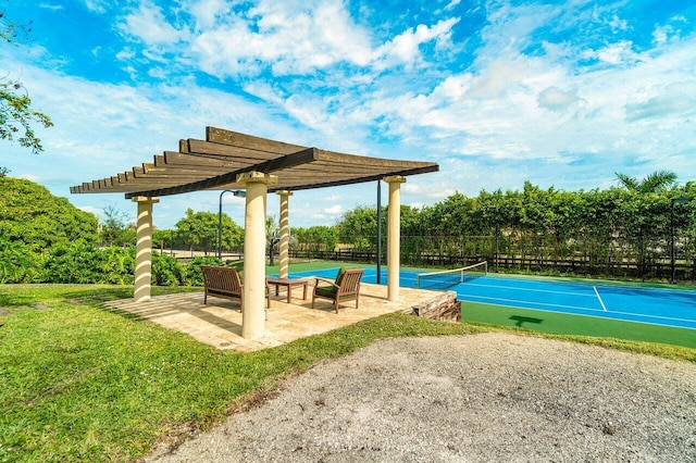 view of swimming pool with a pergola, a patio area, tennis court, and a yard