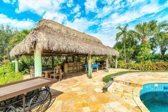 view of terrace with a gazebo and an outdoor bar