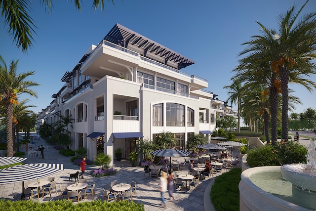 rear view of house featuring a balcony and a patio