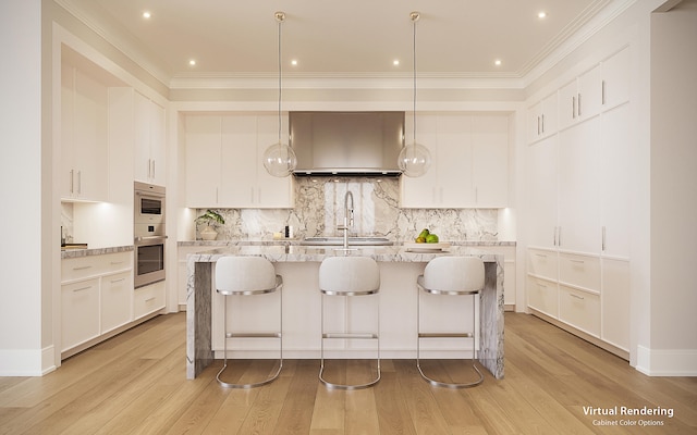 kitchen featuring white cabinetry, pendant lighting, and an island with sink