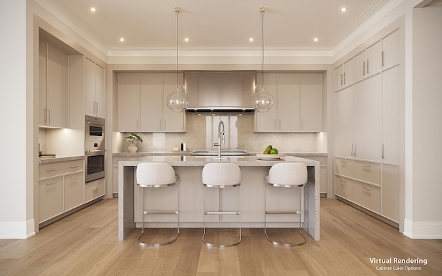 kitchen with an island with sink, hanging light fixtures, and light hardwood / wood-style floors