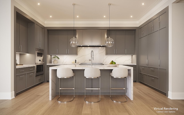 kitchen with decorative light fixtures, light hardwood / wood-style floors, gray cabinets, and a kitchen island with sink