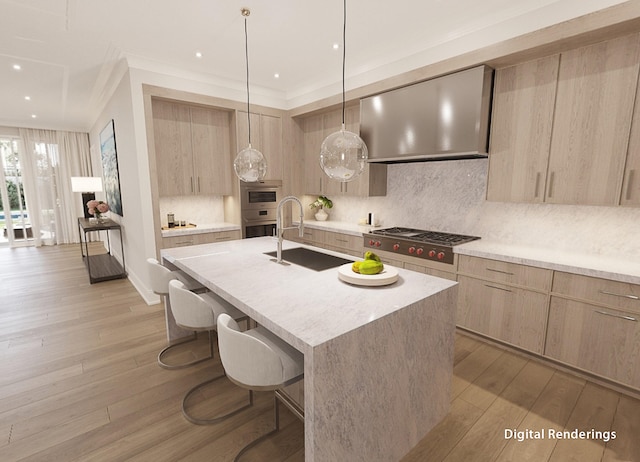 kitchen with a center island with sink, hanging light fixtures, light hardwood / wood-style flooring, and wall chimney range hood