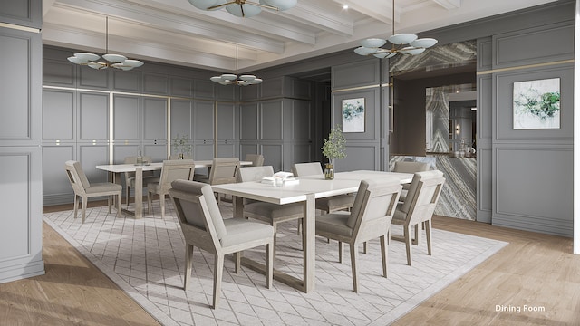 dining space with beam ceiling, a chandelier, light hardwood / wood-style floors, and ornamental molding